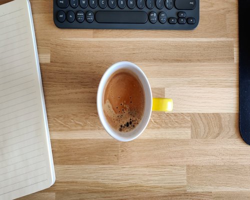 A calm office space with a cup of herbal tea representing the editorial team's workspace