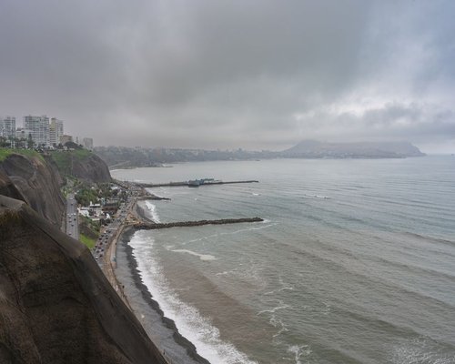 A misty urban view of Lima near the coastline showing the typical high humidity winter weather